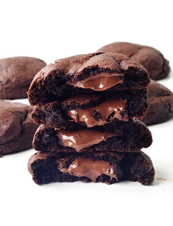 A stack of halved chocolate cookies with molten Nutella centres